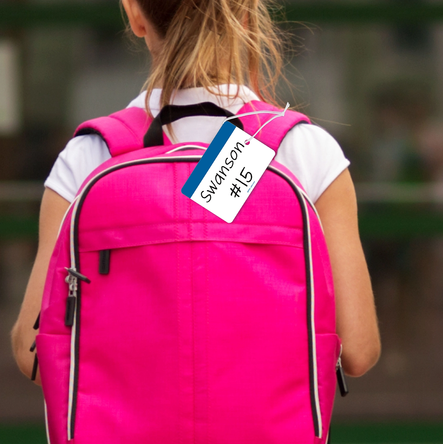 Blue Backpack Tag attached with elastic to girls backpack tag