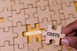 A,Hand,Inserts,A,Puzzle,Piece,Labeled,Hidden,Costs,Into